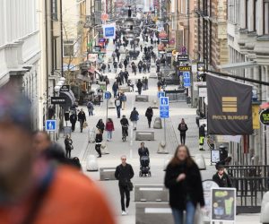 epa08336691 People stroll at Drottninggatan, the main shopping street in Stockholm, Sweden, 27 March 2020 (issued 01 April 2020), amid the coronavirus pandemic. Countries around the world are taking measures to contain the widespread of the SARS-CoV-2 coronavirus which causes the Covid-19 disease.  EPA/Henrik Montgomery  SWEDEN OUT SWEDEN OUT