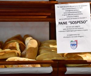 epa08339425 The 'suspended bread', an initiative to offer bread to people in need, realized by a sports club and a bakery store in Oregina district in Genoa, northern Italy, 02 April 2020. Italy is under lockdown in an attempt to stop the widespread of the SARS-CoV-2 coronavirus causing the Covid-19 disease.  EPA/LUCA ZENNARO