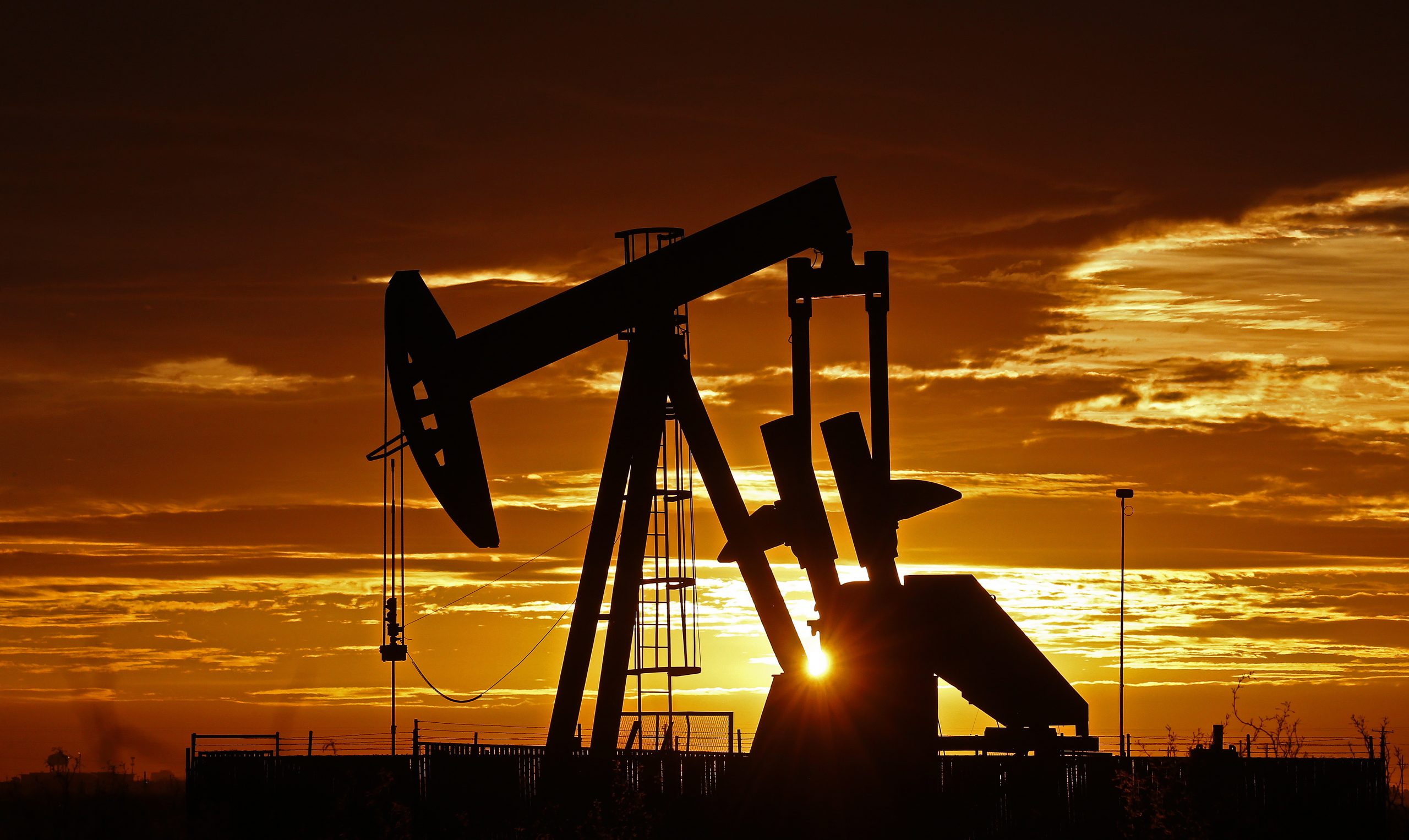 epa08348372 Pump jacks operate in the oil fields near Midland, Texas, USA, at sunrise 07 April 2020. Midland, Texas is a city in western Texas, part of the Permian Basin area. Low oil prices are reportedly causing also the gas prices to drop dramatically.  EPA/LARRY W. SMITH