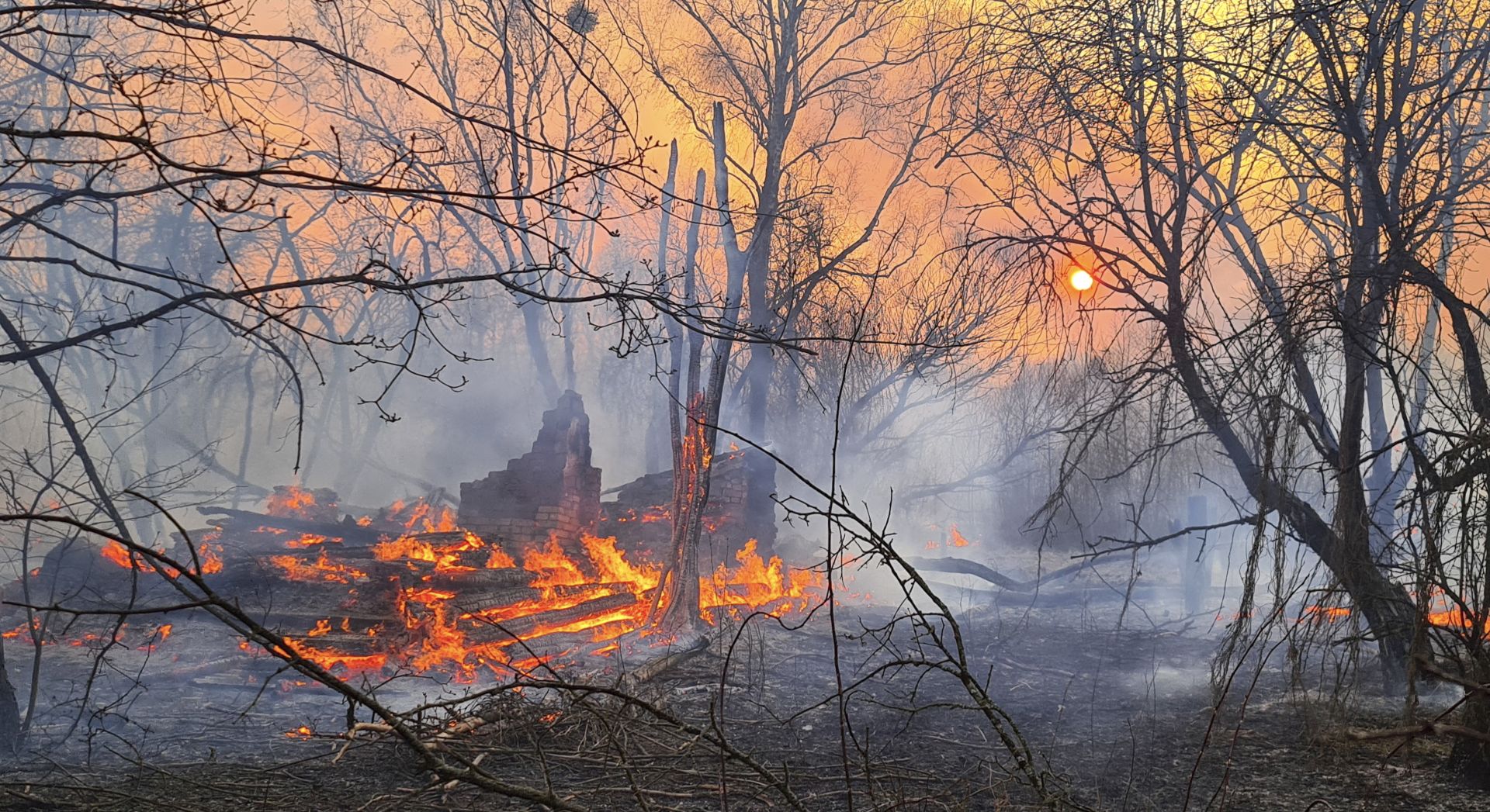epa08348350 A forest fire burns near the village of Volodymyrivka, in the exclusion zone around the Chernobyl nuclear power plant, Ukraine, 05 April 2020 (issued 07 April 2020). Ukraine's State Emergency Service said firefighters and rescue teams continued to put out fires at two sites near Rahivka, adding that radiation levels in the capital, Kyiv (Kiev), and Kyiv region is within a normal range. The total area affected by the fire near Rahivka was reported to be five hectares. The Kyiv police said they have identified on 06 April 2020 a man who allegedly started a mass fire in the uninhabited exclusion zone around the decommissioned Chornobyl nuclear plant last week. The 27-year-old resident of the Rahivka village told investigators that he had set some garbage and grass on fire for fun. The territory is a long-vacated area near where an explosion at the Chernobyl Soviet nuclear plant in April 1986 sent a plume of radioactive fallout high into the air and across swaths of Europe.  EPA/YAROSLAV YEMELIANENKO