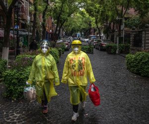 epa08355036 People wearing protective gears walk on a street in Wuhan, China, 10 April 2020. Wuhan, the epicenter of the coronavirus outbreak, lifted the lockdown on 08 April 2020, allowing people to leave the city after more than two months. According to Chinese government figures, over 2,500 people have died of Covid-19 in Wuhan since the outbreak began.  EPA/ROMAN PILIPEY