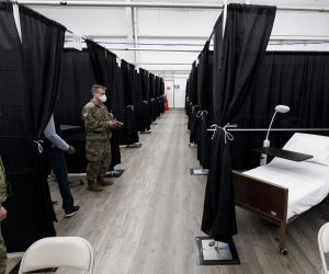 epa08356293 United States Army personnel look over beds in a newly opened temporary hospital facility in one of the practice buildings at the USTA Billie Jean King National Tennis Center in Queens, New York, USA, 10 April 2020. The hospital, set up on the grounds where the US Open tennis tournament is held annually, has 475 beds, including 20 for ICU patients and will handle some COVID-19 patients starting today to help alleviate the stress on traditional area hospitals.  EPA/JUSTIN LANE