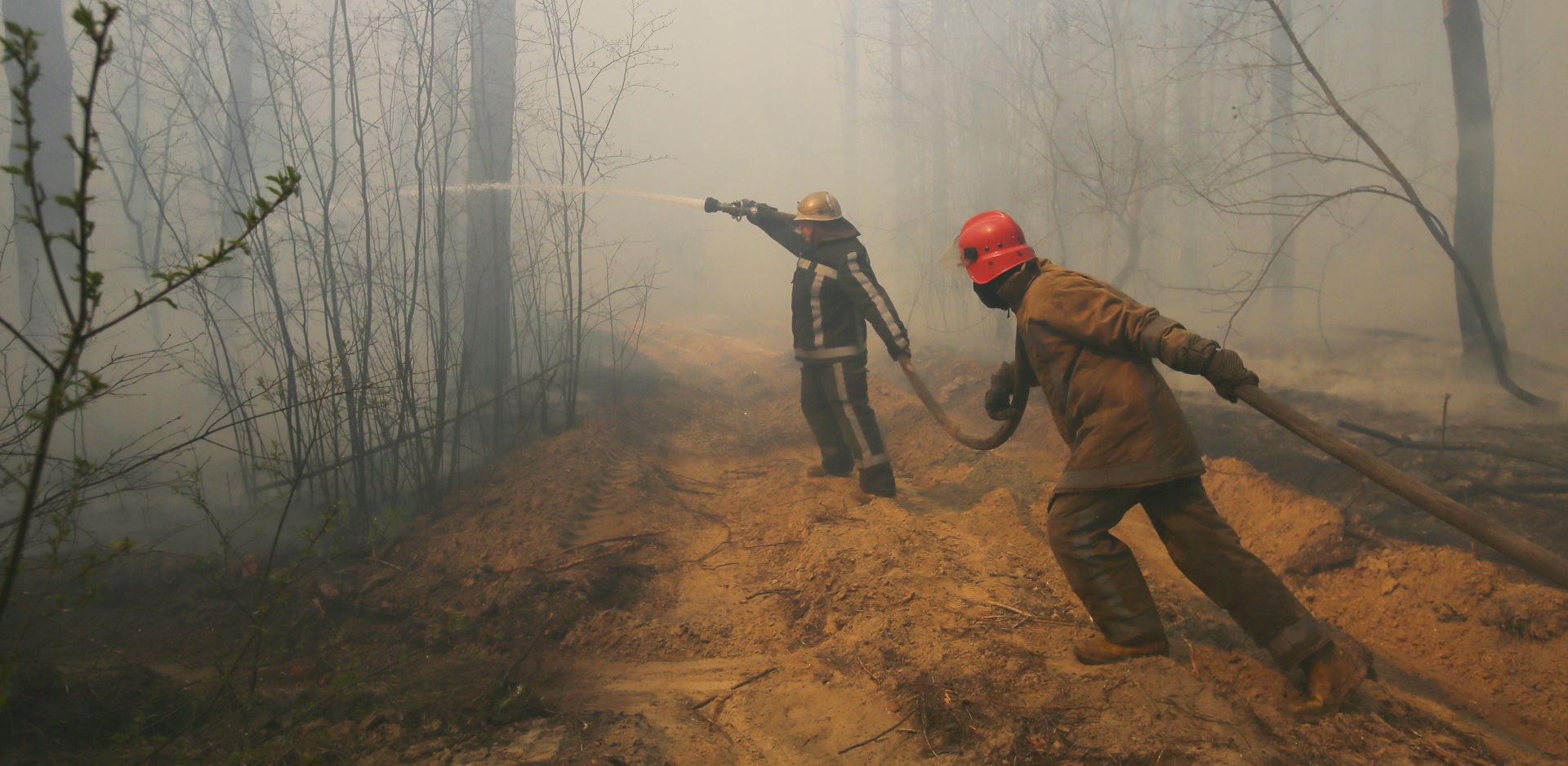 epa08357551 Ukrainian firemen fight with forest fire which burns near the village of Ragovka, close to the exclusion zone around the Chernobyl nuclear power plant, Ukraine, 10 April 2020 (issued 11 April 2020). Officials have been fighting fires in the exclusion zone since 04 April 2020. In early April 2020, NASA satellites observed several wildfires in northern Ukraine around the Chornobyl Exclusion Zone as local media report. Hundreds of firefighters and at least eight airborne units were working to extinguish fires in the Denysovets, Kotovsky, and Korogodsky forests, NASA's Earth Observatory reports. The territory is a long-vacated area near where an explosion at the Chernobyl Soviet nuclear plant in April 1986 sent a plume of radioactive fallout high into the air and across swaths of Europe.  EPA/STR