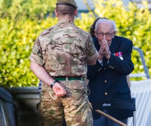 epa08365722 99-year-old British veteran Captain Tom Moore (R) reacts as he completes the 100th length of his back garden in Marston Moretaine, Bedfordshire, Britain, 16 April, 2020. Captain Tom Moore has raised over £12 million for Britain’s National Health Service (NHS) and has received donations to his fundraising challenge from around the world.  EPA/VICKIE FLORES