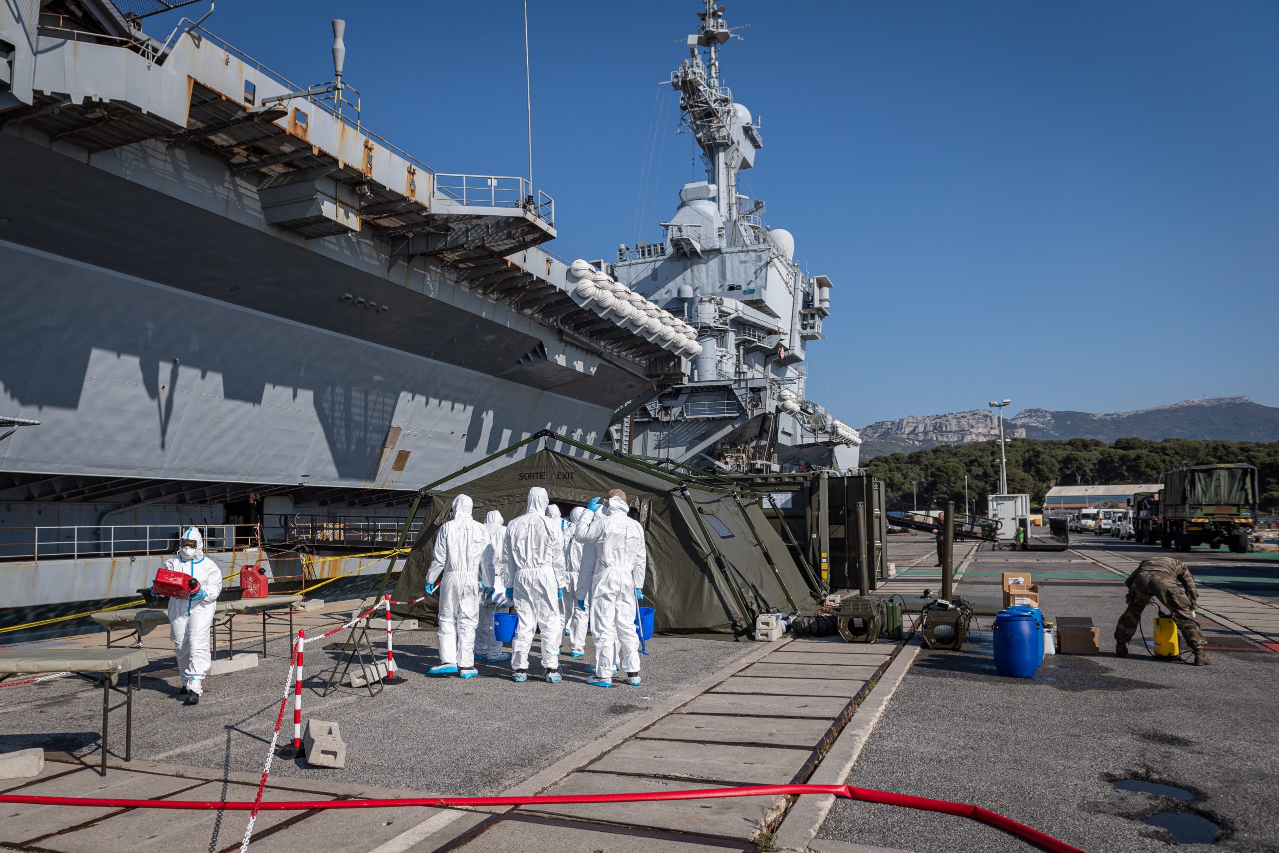 epa08367136 A handout photo made available by the French Defense Ministry on 16 April 2020 shows officers getting prepared to work on cleaning and disinfecting the French nuclear aircraft carrier Charles De Gaulle in Toulon, France, 15 April 2020. The French Defense Minister announced on 15 April 2020 that 668 people tested positive for the coronavirus in the aircraft carrier Charles de Gaulle.  EPA/BENOIT EMILE  HANDOUT EDITORIAL USE ONLY/NO SALES