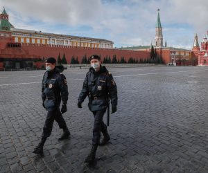 epa08368910 Police officers wearing protective masks walk on the Red Square in front of the Kremlin in Moscow, Russia, 17 April 2020. Russian President Vladimir Putin extended the current nationwide lockdown with stay-at-home orders until the end of April in a bid to slow down the spread of the pandemic COVID-19 disease caused by the SARS-CoV-2 coronavirus.  EPA/YURI KOCHETKOV