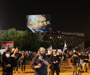epa08372035 Israelis protest against government corruption and for democracy at Rabin square in Tel Aviv, Israel, 15 April 2020. Reports state that around 2,000 people took part in the demonstration keeping two meters distance from each other in order to prevent the spread of the SARS-CoV-2 coronavirus which causes he Covid-19 disease.  EPA/ABIR SULTAN