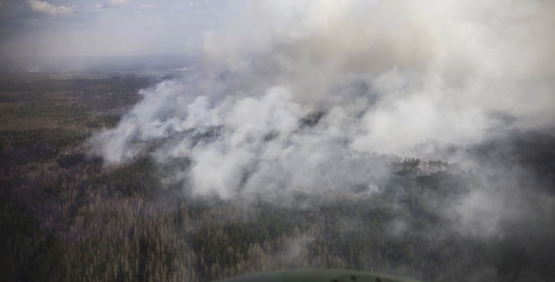 epa08372152 A handout photo made available by the Presidential press service shows a wildfire in Zhytomyr region in Ukraine, 19 April 2020. Wildfires in Zhytomyr region and the Chornobyl exclusion zone broke out on 04 April 2020. Ukraine's Interior Minister Avakov noted that the elimination of fires in the Chornobyl exclusion zone is still ongoing. Now all the causes of fires are being established. So far, rescuers and police are considering snowless winter and dry forest litter as the main course of the wildfires.  EPA/PRESIDENTIAL PRESS SERVICE / HANDOUT  HANDOUT EDITORIAL USE ONLY/NO SALES