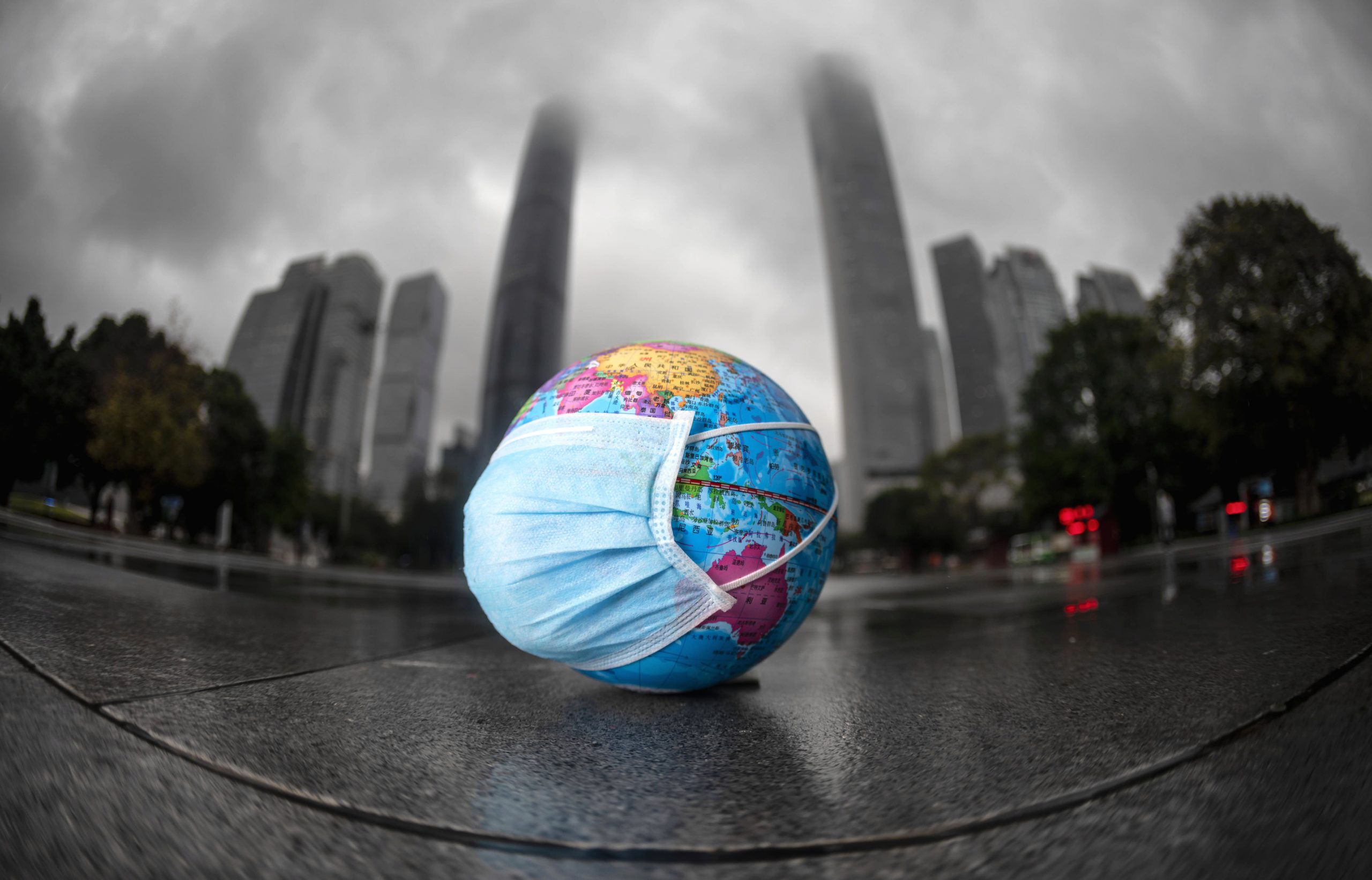 epa08376968 A model of the globe with a face mask left on the ground by the children who were playing with it in Guangzhou, Guangdong province, China, 22 April 2020. World Earth Day is marked in many countries annually on 22 April to raise awareness of environmental protection.  EPA/ALEX PLAVEVSKI