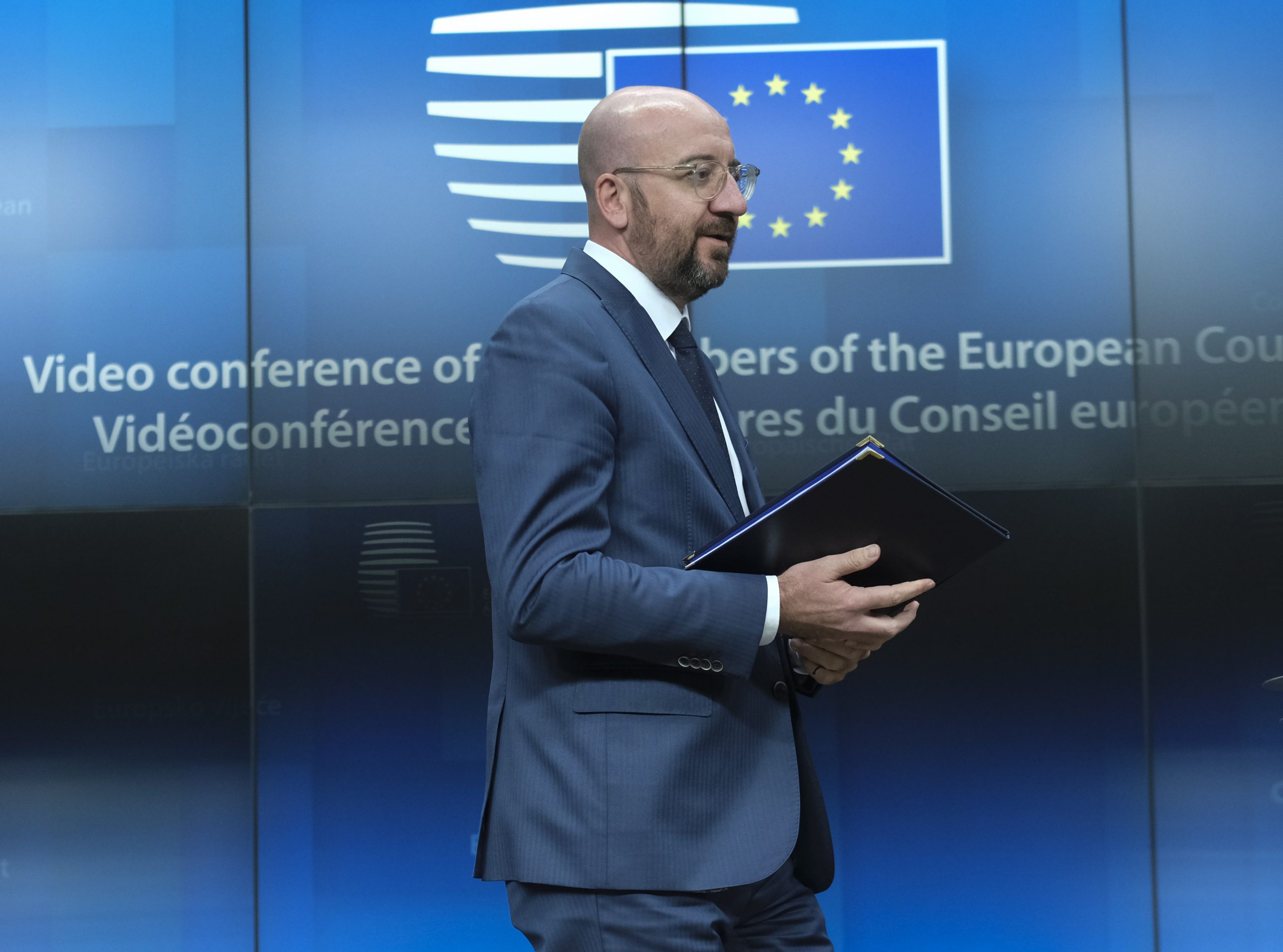 epa08380378 European Council President Charles Michel arrives for a joint a news conference with European Commission President Ursula Von Der Leyen (unseen) after a video conferenced EU summit with  European heads of state and governments to discuss measures related to the COVID-19 disease, in Brussels, Belgium, 23 April 2020.  EPA/OLIVIER HOSLET / POOL