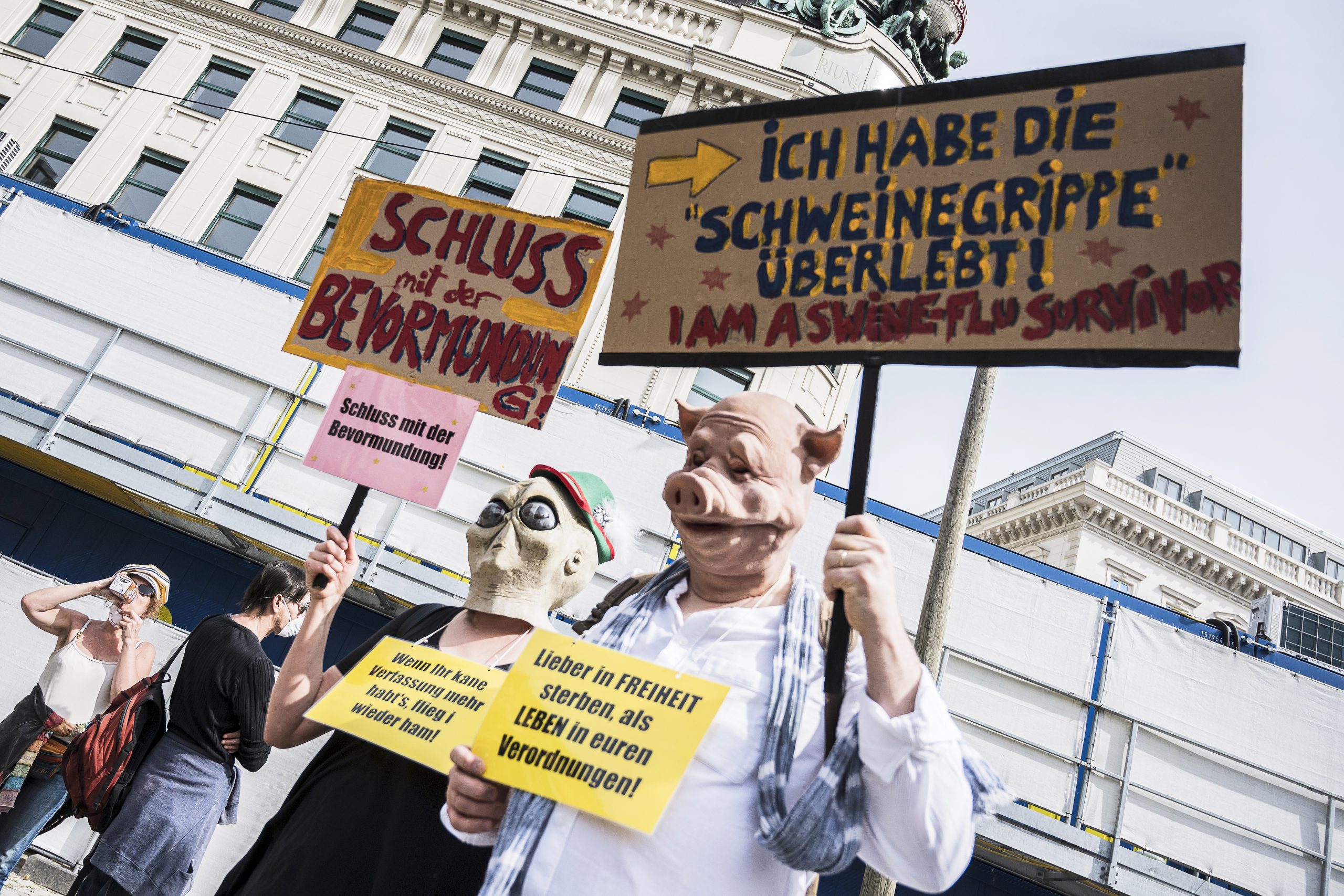 epa08382408 Participants hold signs during a demonstration against the measures of the Austrian government to slow down the ongoing pandemic of the COVID-19 disease caused by the SARS-CoV-2 coronavirus in Vienna, Austria, 24 April 2020.  EPA/CHRISTIAN BRUNA