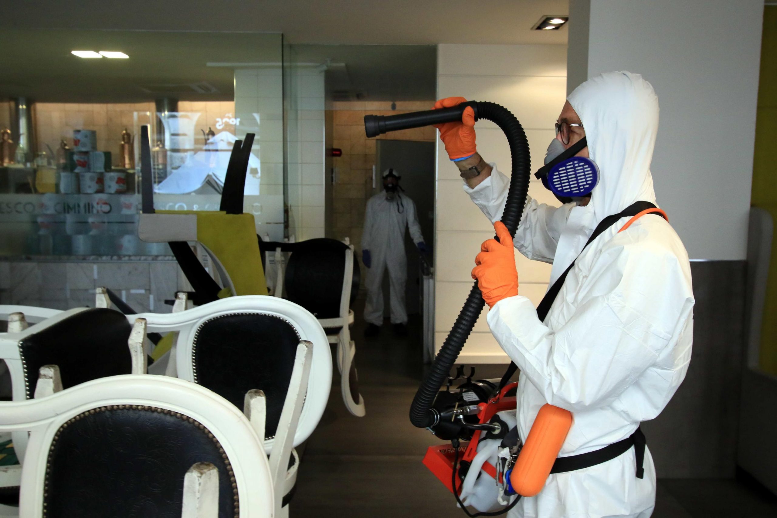 epa08393630 Workers sanitize a restaurant at Vittorio Emanuele Gallery in Milan, Italy, 30 April 2020. Countries around the world are taking increased measures to stem the widespread of the SARS-CoV-2 coronavirus which causes the COVID-19 disease.  EPA/PAOLO SALMOIRAGO