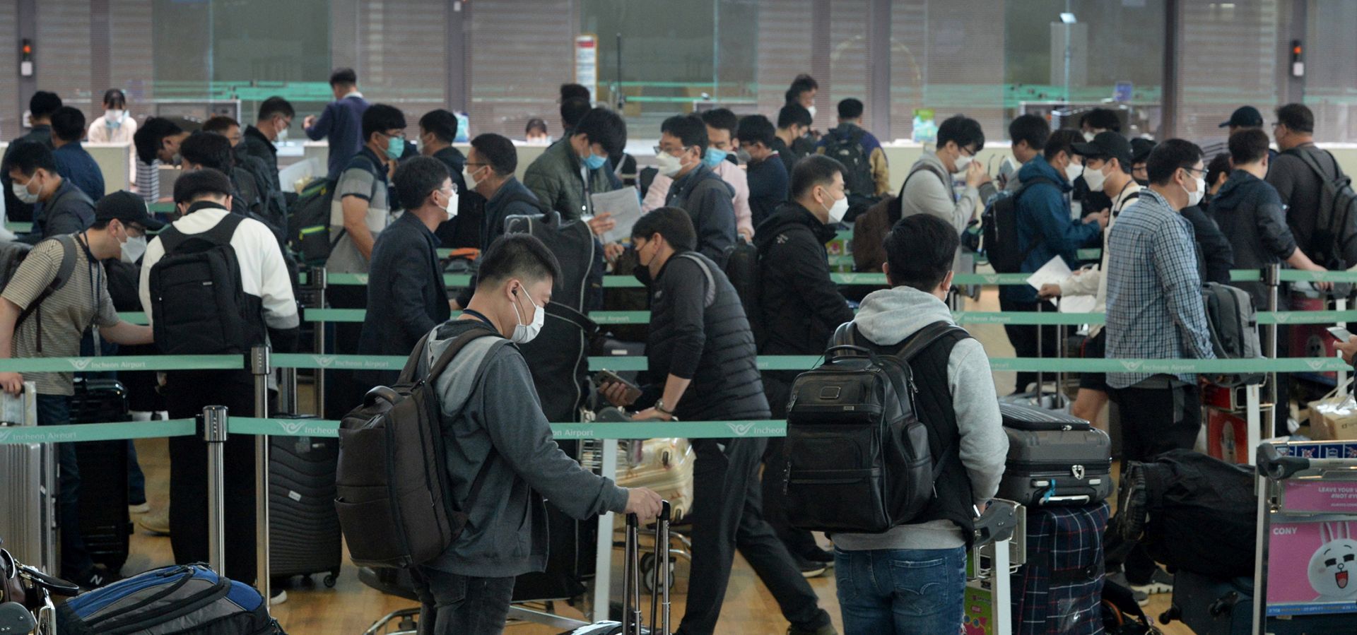 epa08390610 A group of South Korean businessmen wait at check-in counters at Incheon airport, west of Seoul, on April 29, 2020, before their departure for Vietnam. The Southeast Asian country has granted 340 South Korean business travelers exemptions to its coronavirus entry ban. The exemptions came amid Seoul's stepped-up diplomacy to persuade foreign countries to allow essential overseas trips by businessmen, as part of a broader effort to limit the economic repercussions of the COVID-19 pandemic  EPA/YONHAP SOUTH KOREA OUT