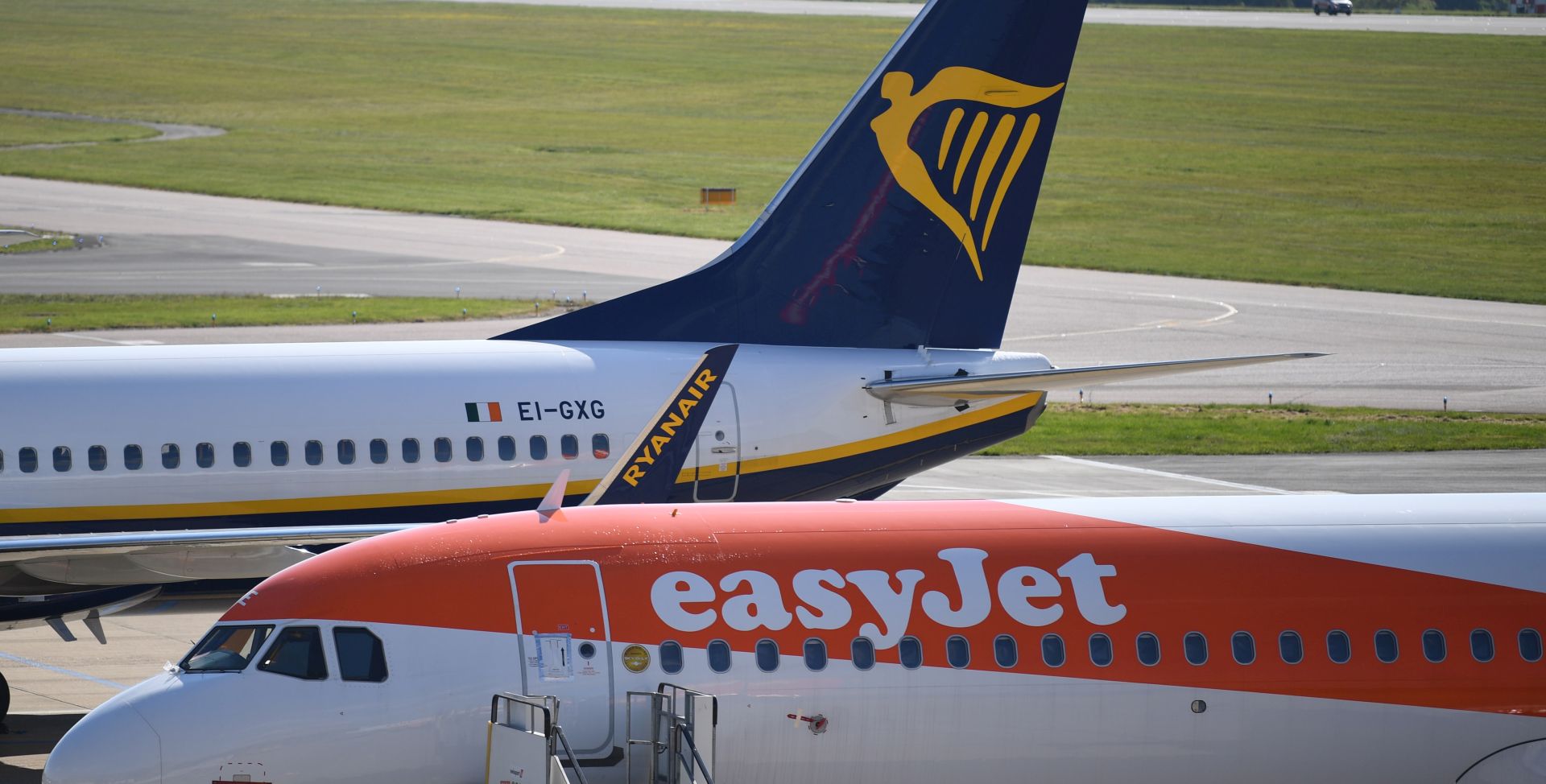 epa08397412 EasyJet and Ryanair aircraft are parked at Luton Airport, in Britain, 02 May 2020.  Due to the coronavirus number UK daily flights has fallen and in some routes have been suspended. British Airways' parent company IAG announced it is set to cut up to 12,000 positions. Easyjet has laid off its 4,000 UK-based cabin crew for two months. Countries around the world are taking increased measures to stem the widespread of the SARS-CoV-2 coronavirus which causes the Covid-19 disease.  EPA/NEIL HALL