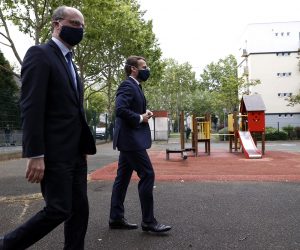 epa08402133 French President Emmanuel Macron (R) and French Education Minister Jean-Michel Blanquer (L) wear protective facial masks as they arrive for a visit of the Pierre de Ronsard elementary school in Poissy, France, 05 May 2020. Questions rise about the reopening of schools on the eve France's gradual exit from lockdown on 11 May.  EPA/IAN LANGSDON / POOL