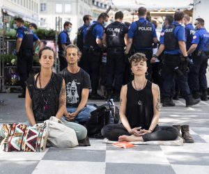 epa08412119 Demonstrators sit on the ground and refuse to leave, while several hundred demonstrators gathered to protest against the ongoing Corona-Lockdown, in the center of Bern, Switzerland, 09 May 2020. The demonstrators asked for more freedom and personal responsibility. The police tried to end the demonstration but refrained to use force to dissolve it.  EPA/PETER KLAUNZER