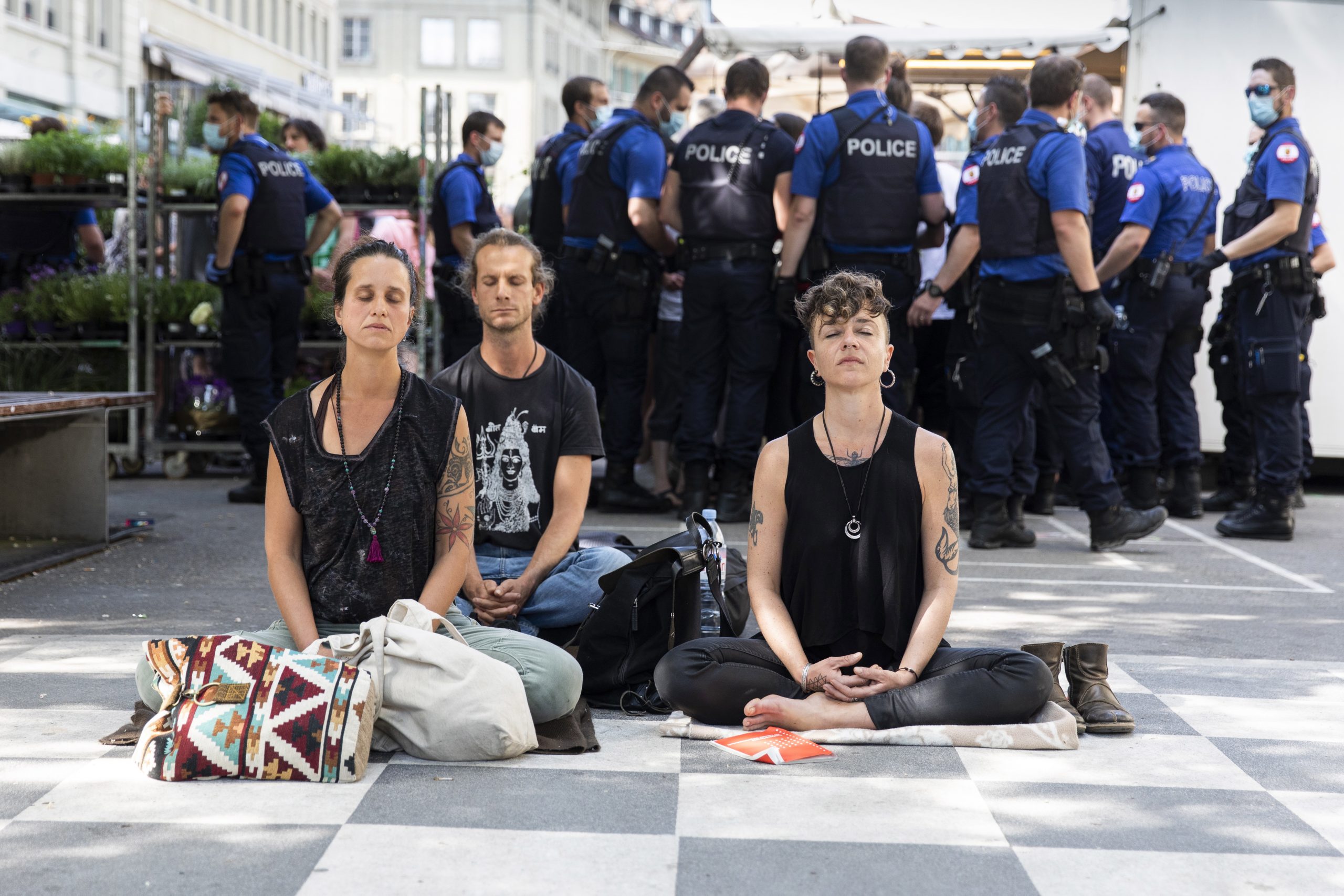 epa08412119 Demonstrators sit on the ground and refuse to leave, while several hundred demonstrators gathered to protest against the ongoing Corona-Lockdown, in the center of Bern, Switzerland, 09 May 2020. The demonstrators asked for more freedom and personal responsibility. The police tried to end the demonstration but refrained to use force to dissolve it.  EPA/PETER KLAUNZER