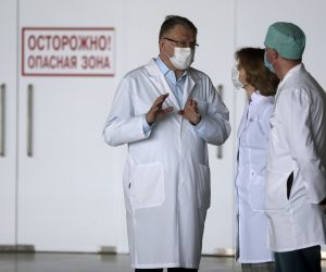 epa08415004 Konstantin Sobolev (L), the chief doctor of the Krasnogorsk Hospital , talks to colleagues at the temporary hospital for COVID-19 patients at the Crocus City exhibition center in Moscow, Russia, 11 May 2020. A new hospital with a capacity of up to 1,000 patients infected with the SARS-CoV-2 coronavirus has been set up and deployed at the exhibition center and is expected to receiving first patients on 12 May 2020.  EPA/SERGEI CHIRIKOV
