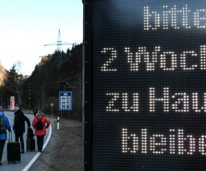 epa08418768 (FILE) - A group of tourists walks past a warning sign reading 'Please stay at home for two weeks', at the border between Germany and Austria, in Scharnitz, Germany, 16 March 2020 (reissued 13 May 2020). Media reports state on 13 May 2020 that Germany is planning to partially ease border controls as early as 16 May 2020, following a decision of the Cabinet. At the same time, Austria is planning to reopen the border with Germany as early as 15 June, media added.  EPA/PHILIPP GUELLAND *** Local Caption *** 55955912