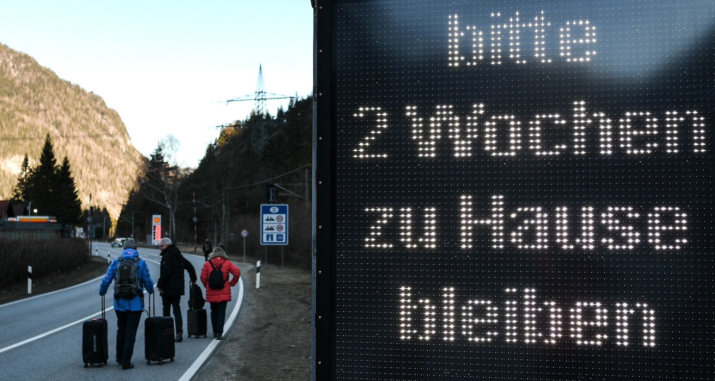 epa08418768 (FILE) - A group of tourists walks past a warning sign reading 'Please stay at home for two weeks', at the border between Germany and Austria, in Scharnitz, Germany, 16 March 2020 (reissued 13 May 2020). Media reports state on 13 May 2020 that Germany is planning to partially ease border controls as early as 16 May 2020, following a decision of the Cabinet. At the same time, Austria is planning to reopen the border with Germany as early as 15 June, media added.  EPA/PHILIPP GUELLAND *** Local Caption *** 55955912