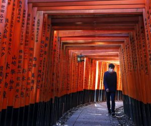 epaselect epa08419145 A man wearing a protective face mask walks through the Senbon Torii (Thousands Torii Gates), a tunnel of torii gates, at Fushimi Inari Taisha Shrine in Kyoto, Japan, 13 May 2020, amid the ongoing coronavirus COVID-19 pandemic. The streets of Japan's ancient capital Kyoto and its world-famous tourist spots are largely deserted as the number of foreign visitors declined more than 93 per cent from previous year, the local media reported in late April. Japan's tourism industry has been hit hard by the COVID-19 crisis risking millions of jobs. The Japanese government extended the nationwide state of emergency until 31 May, in a bid to curb the spread of the coronavirus SARS-CoV-2 which causes the COVID-19 disease.  EPA/DAI KUROKAWA