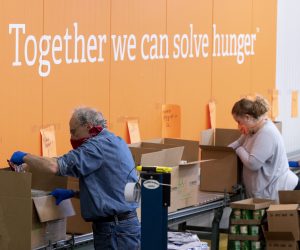 epa08422823 Volunteers pack boxes with food items to be donated to those in need, on an assembly line at Capital Area Food Bank (CAFB) in Washington, DC, USA, 14 May 2020. CAFB typically donates about 32 million meals annually, with that figure expected to increase in 2020 amid the coronavirus COVID-19 pandemic. The increase is in spite of the closure of nonprofit partners and a seventy-five percent decrease in retail donations. The pandemic has caused up to a four hundred percent increase in numbers of people coming through the doors of CAFB's nonprofit partners.  EPA/MICHAEL REYNOLDS