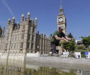epa08431762 A gardener works on the Palace of Westminster and Big Ben at the Mini-Europe attraction park in Brussels, Belgium, 19 May 2020. The miniature theme park featuring the main sights of the 28 member countries of the European Union reopened after the winter season and set up border and Custom controls between United Kingdom and the EU, as the UK had left the bloc after 31 January.  EPA/OLIVIER HOSLET