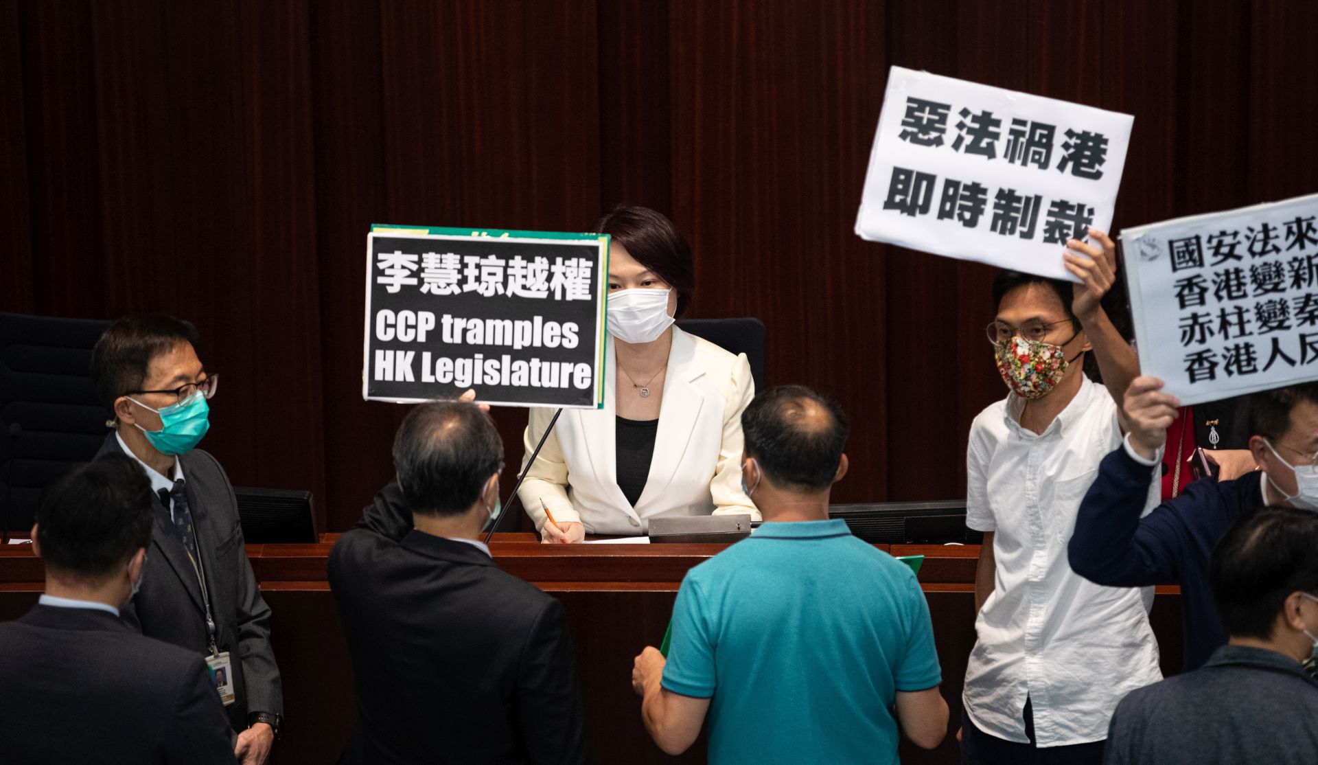 epa08436911 Pro-Beijing lawmaker and House Committee chairperson Starry Lee (C) is confronted by pan-democrat lawmakers at the Legislative Council in Hong Kong, China, 22 May 2020. China announced that it will introduce a new national security law in Hong Kong banning sedition, secession and subversion of the central government in Beijing through a method that could bypass Hong Kong's legislature.  EPA/JEROME FAVRE