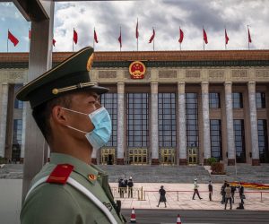 epa08443149 A Chinese People's Liberation Army (PLA) soldier wearing a protective face mask stands guard in front of the Great Hall of the People before the second plenary session of China's National People's Congress (NPC) in Beijing, China, 25 May 2020. The NPC runs alongside the annual plenary meetings of the Chinese People's Political Consultative Conference (CPPCC), together known as 'Lianghui' or 'Two Meetings'. This year the two major political meetings initially planned to be held in March were postponed amid the ongoing coronavirus COVID-19 pandemic.  EPA/ROMAN PILIPEY / POOL