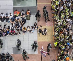 epaselect epa08446614 A large group of detainees are seen sitting on the ground as police has set up a police cordon around the area in Causeway Bay, Hong Kong, China, 27 May 2020. The Second Reading debate on the National Anthem Bill is set to resume at the Legislative Council on 27 May amid growing anger at Beijing's plan to impose a national security law on the city banning sedition, secession and subversion through a method that could bypass Hong Kong's legislature.  EPA/MIGUEL CANDELA