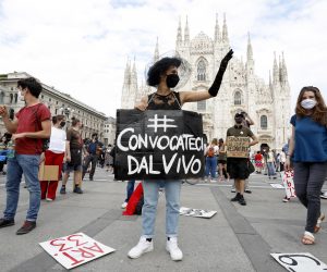 epa08454589 Workers from the arts, culture and entertainment industries take part in a flash mob and demonstration in Milan, Italy, 30 May 2020, during Phase 2 of the coronavirus disease (COVID-19) pandemic. According to media reports, the workers from the arts, culture and entertainment industries demonstated calling on the government for new rules allowing the resumption of live shows. Banner reads 'Summon us live'.  EPA/Mourad Balti Touati