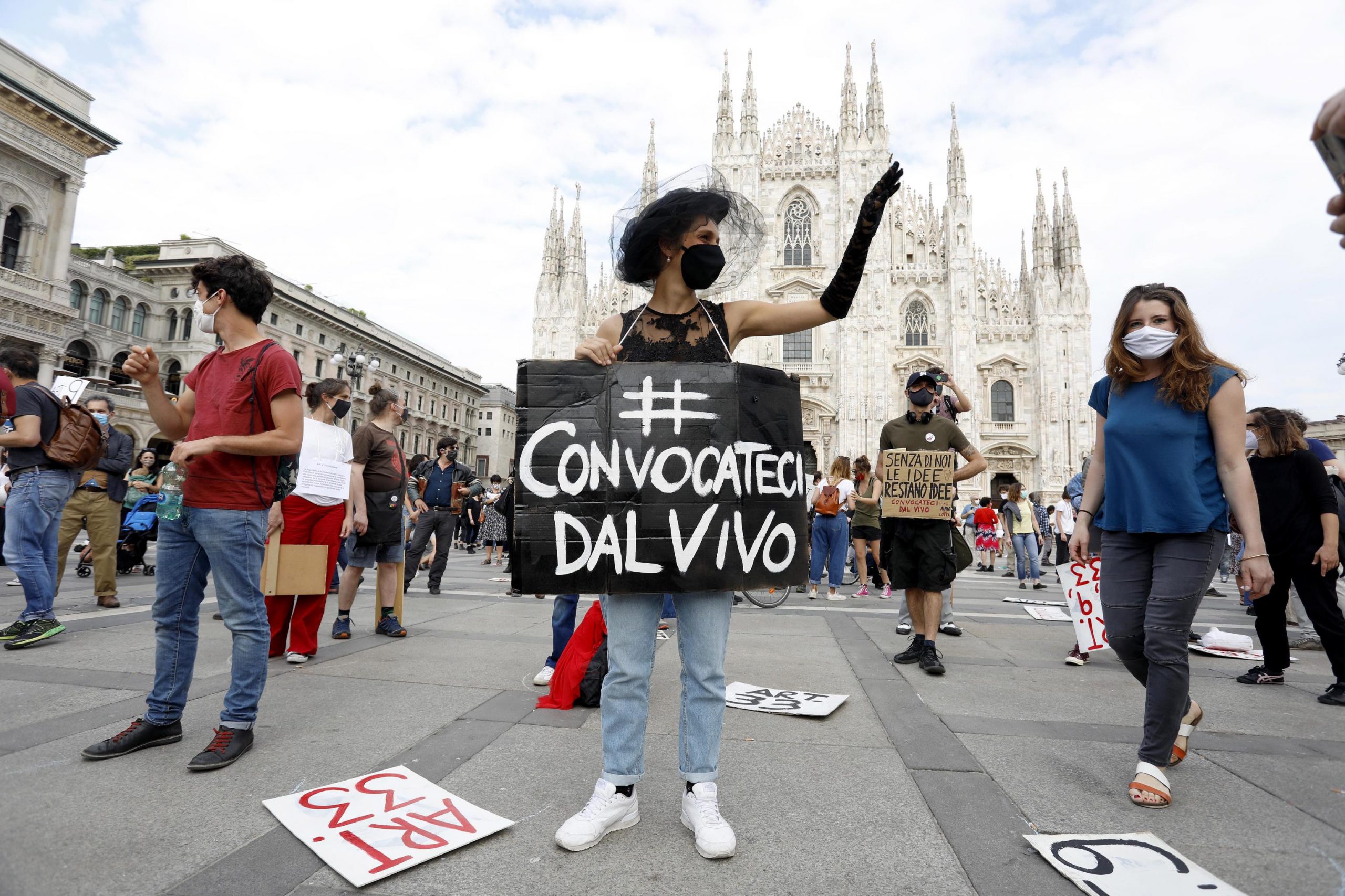 epa08454589 Workers from the arts, culture and entertainment industries take part in a flash mob and demonstration in Milan, Italy, 30 May 2020, during Phase 2 of the coronavirus disease (COVID-19) pandemic. According to media reports, the workers from the arts, culture and entertainment industries demonstated calling on the government for new rules allowing the resumption of live shows. Banner reads 'Summon us live'.  EPA/Mourad Balti Touati