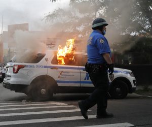 epa08455208 A New York City Police Department vehicle burns after being set alight by protesters as they demostrate about the arrest of George Floyd, who later died in police custody, in Brooklyn, New York, USA, 30 May 2020. A bystander's video posted online on 25 May, appeared to show George Floyd, 46, pleading with arresting officers that he couldn't breathe as an officer knelt on his neck. The unarmed black man later died in police custody.  EPA/KEVIN HAGEN