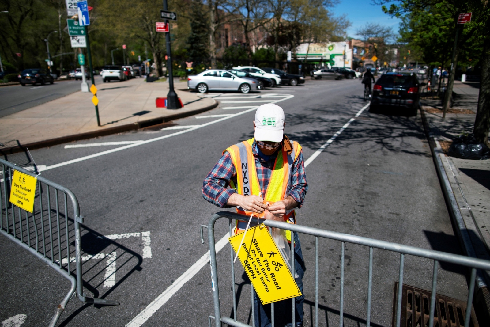 The spread of the coronavirus disease (COVID-19) in New York A worker places information as he closes a street to be used by pedestrians for ensuring that social distancing norms are maintained, during the outbreak of the coronavirus disease (COVID-19) in the Manhattan borough of New York City, U.S., May 2, 2020. REUTERS/Eduardo Munoz EDUARDO MUNOZ