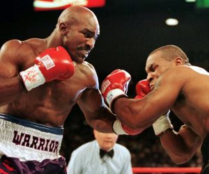 FILE PHOTO: WBA Heavyweight Champion Evander Holyfield (R) connects to the jaw of challenger Mike Tyson in the f.. FILE PHOTO: WBA Heavyweight Champion Evander Holyfield (R) connects to the jaw of challenger Mike Tyson in the first round of their title fight June 28.  Evander Holyfied retained his World Boxing Association heavyweight title on Saturday night when Mike Tyson was disqualified for biting Holyfield twice in the third round./File Photo Gary Hershorn