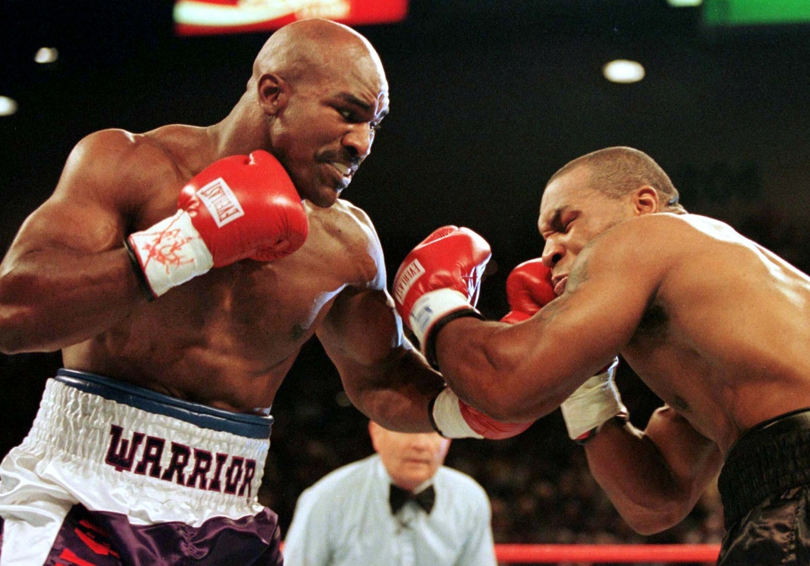 FILE PHOTO: WBA Heavyweight Champion Evander Holyfield (R) connects to the jaw of challenger Mike Tyson in the f.. FILE PHOTO: WBA Heavyweight Champion Evander Holyfield (R) connects to the jaw of challenger Mike Tyson in the first round of their title fight June 28.  Evander Holyfied retained his World Boxing Association heavyweight title on Saturday night when Mike Tyson was disqualified for biting Holyfield twice in the third round./File Photo Gary Hershorn