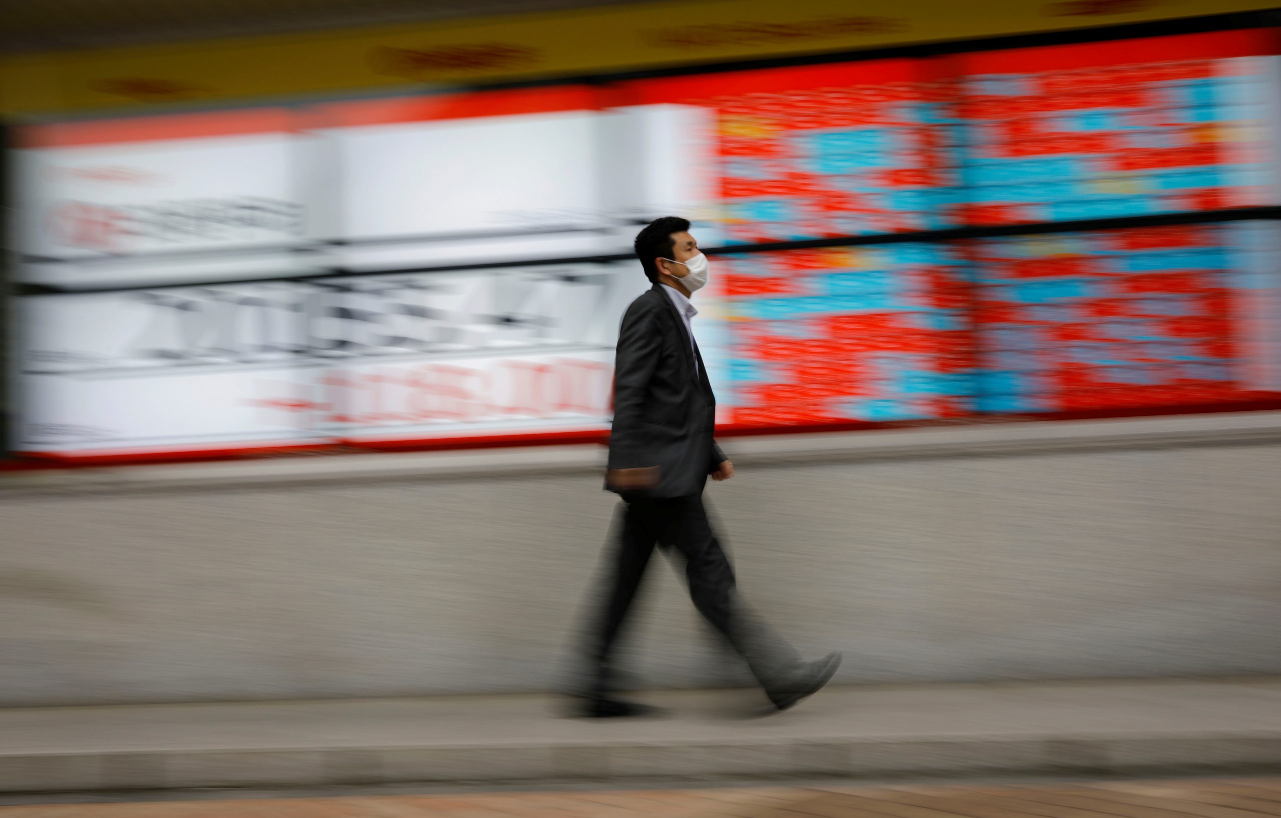 A man wearing a protective face mask, following the coronavirus disease (COVID-19) outbreak, walks in front of a stock quotation board outside a brokerage in Tokyo A man wearing a protective face mask, following the coronavirus disease (COVID-19) outbreak, walks in front of a stock quotation board outside a brokerage in Tokyo, Japan, May 18, 2020. REUTERS/Kim Kyung-Hoon KIM KYUNG-HOON