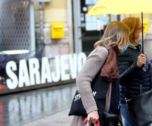 epa08444481 Two women walk past with an umbrella during a rainy day in Sarajevo, Bosnia and Herzegovina, 26 May 2020. Countries around the world are taking increased measures to stem the widespread of the SARS-CoV-2 coronavirus which causes the COVID-19 disease.  EPA/FEHIM DEMIR