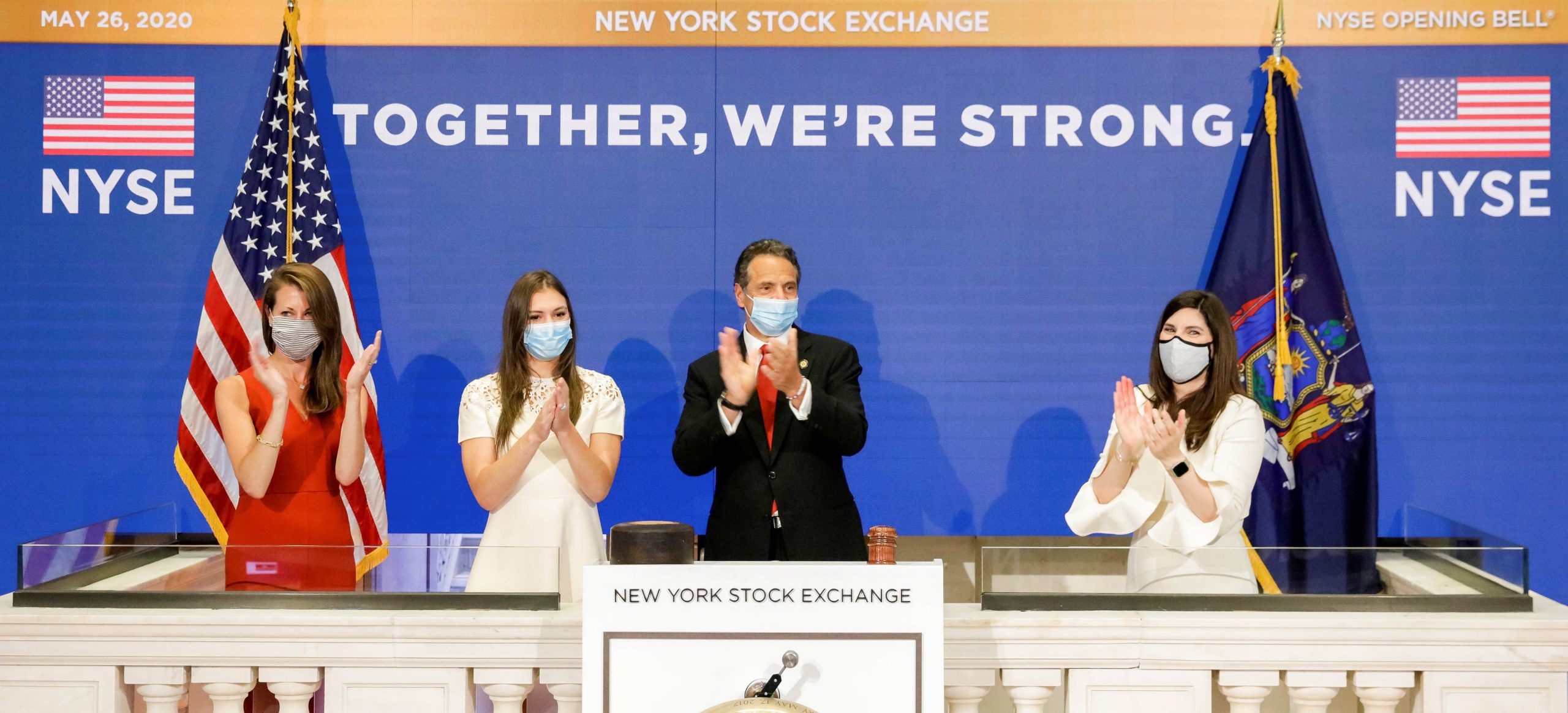 epa08446152 A handout photo made available by the New York Stock Exchange (NYSE) shows New York Governor Andrew Cuomo (C) clap while ringing the Opening Bell of the New York Stock Exchange and standing with NYSE President Stacey Cunningham (R), Melissa DeRosa (L), Secretary to the governor, and Mariah Kennedy Cuomo (2-L), the governor’s daughter, at the New York Stock Exchange in New York, New York, USA, on 26 May 2020. Today is the first day that the stock exchange is reopen for in-person trading after the building was closed in March due to the coronavirus pandemic.  EPA/NYSE HANDOUT  HANDOUT EDITORIAL USE ONLY/NO SALES
