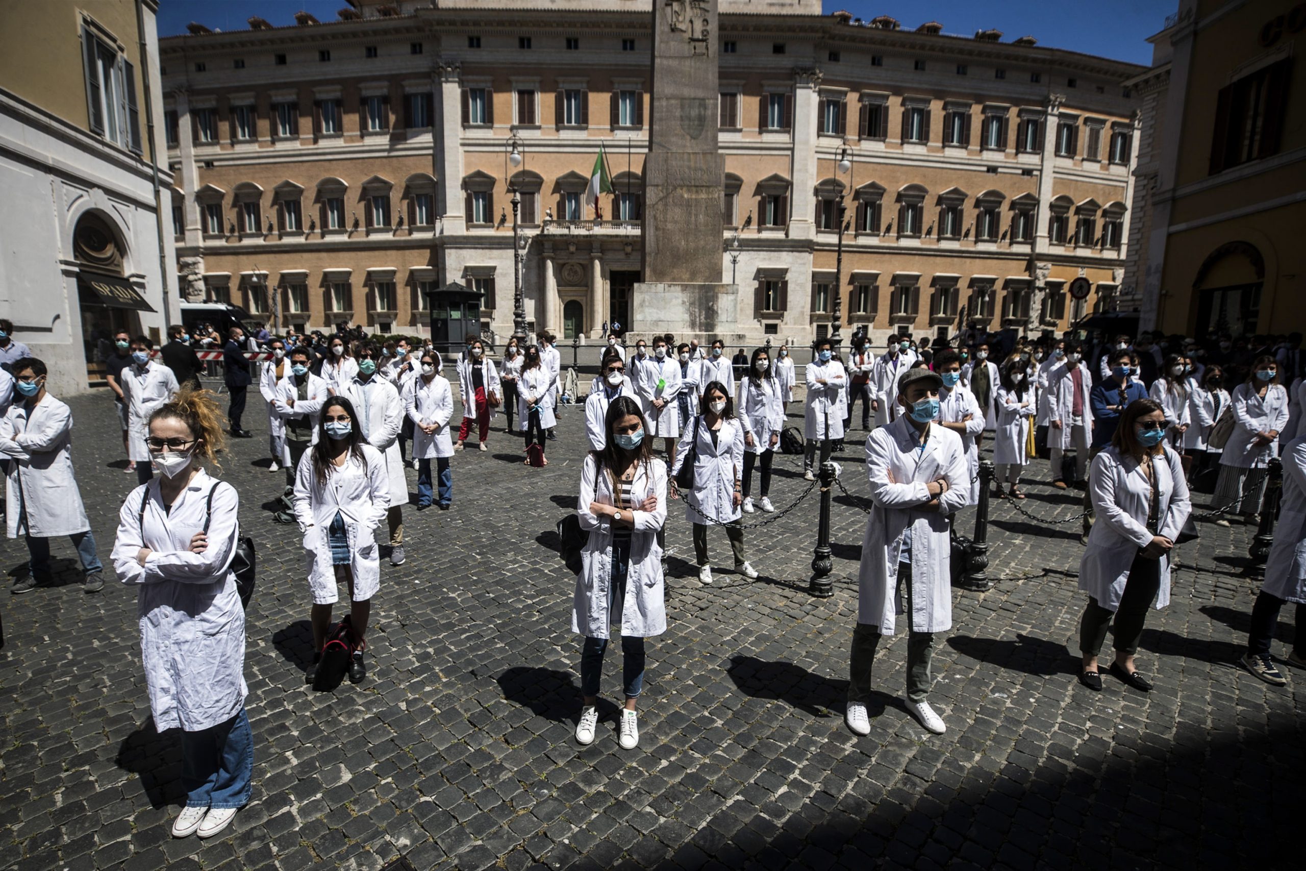 epaselect epa08446923 Medical students, graduate students and young doctors protest in front of the Italian Parliament during the second phase of the coronavirus disease (COVID-19) pandemic, emergency in Rome, Italy, 27 May 2020. According to media reports, demonstrators denounced the fragility of the national health system.  EPA/ANGELO CARCONI