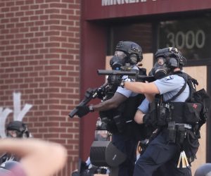 epa08448787 Minneapolis police in riot gear outside the 3rd Precinct as a second day of protests continue over the arrest of George Floyd, who later died in police custody, in Minneapolis, Minnesota, USA, 27 May 2020. A bystander's video posted online on 25 May appeared to show George Floyd, 46, pleading with arresting officers that he couldn't breathe as an officer knelt on his neck. The unarmed black man later died in police custody.  EPA/TANNEN MAURY