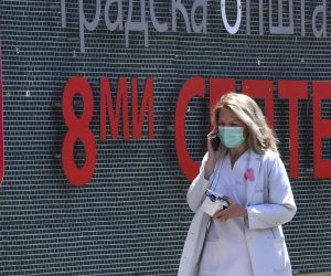 epa08462707 A medical staff in a protective mask walks outside of the city hospital 8-th September in Skopje, North Macedonia, 03 June 2020. A week ago the North Macedonian Government decided to drop the restrictive measures which were in place due to the coronavirus COVID-19 pandemic. According the official statistic in the last two days, North Macedonia have more newly infected people with COVID - 19 than all neighboring countries together.  EPA/GEORGI LICOVSKI