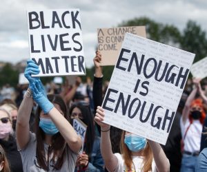 epa08471438 Protesters hold placards during a 'Black Lives Matter' (BLM) demonstration at Glasgow Green, Glasgow, Britain, 07 June 2020. Thousands of people defy the coronavirus lockdown order to take part in the anti-racism demonstration held to condemn the killing of George Floyd, a 46-year-old African-American man who died on 25 May after being detained by police officers in Minneapolis (Minnesota), USA, and to express solidarity with the BLM-led protests currently taking place throughout the US.  EPA/ROBERT PERRY