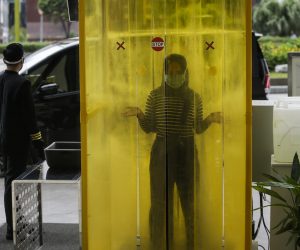 epa08474325 A worker stands inside a disinfectant chamber at the entrance to Senayan City shopping mall in Jakarta, Indonesia, 09 June 2020. The shopping mall prepares to reopen after the Indonesian government has started to ease coronavirus COVID-19 lockdown restrictions in an effort to restart the economies and help people in their daily routines after the outbreak of coronavirus pandemic.  EPA/MAST IRHAM