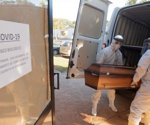 epa08477397 Funeral workers move caskets of coronavirus fatalities to a separate location, prior to burial at the Campo da Esperança cemetery in Brasilia, Brazil, 10 June 2020.  EPA/Joedson Alves