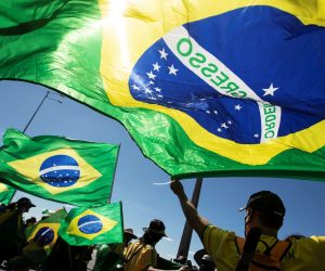 epa08485510 Supporters of the Brazilian President wave Brazil's national flags during a rally to show their support, in Brasilia, Brazil, 14 June 2020.  EPA/Joedson Alves