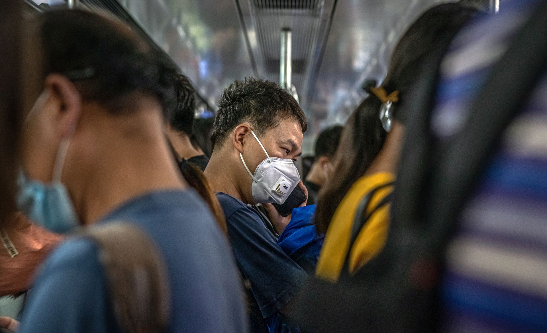 epa08493928 A man wearing a protective face mask rides the subway during an evening rush hour, in Beijing, China, 18 June 2020. Chinese health authorities said that they received reports of 28 new confirmed COVID-19 cases on 17 June of which 21 cases were reported in Beijing. Authorities gave COVID-19 nucleic acid tests to 356,000 people since 13 June, according to the city's government officials, as the number of new coronavirus cases is continuing to increase in the city.  EPA/ROMAN PILIPEY