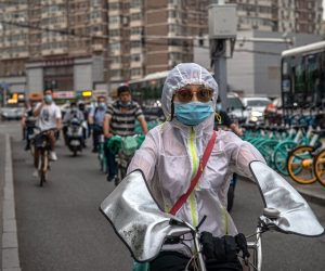 epa08494007 A woman wearing a protective face mask rides a scooter during an evening rush hour, in Beijing, China, 18 June 2020. Chinese health authorities said that they received reports of 28 new confirmed COVID-19 cases on 17 June of which 21 cases were reported in Beijing. Authorities gave COVID-19 nucleic acid tests to 356,000 people since 13 June, according to the city's government officials, as the number of new coronavirus cases is continuing to increase in the city.  EPA/ROMAN PILIPEY