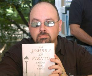 epa08495283 (FILE) - Spanish author Carlos Ruiz Zafon poses for a photograph while holding up a copy of his bestselling novel during a book-signing event at the Madrid Book Fair in Madrid, Spain, 28 May 2005 (reissued 19 June 2020). Zafon passed away at the age of 55 in Los Angeles, USA, after a long struggle against colon cancer, according to a press release by the publishing house Planeta, which worked extensively with the Spanish novelist over two decades of prolific partnership. The author of bestsellers such as 'The Shadow of the Wind' (2001) and 'The Labyrinth of Spirits' (2016) had been a resident of LA since 1993. Born in Barcelona in 1964, Zafon got by as a publicist and screenwriter before earning literary fame and critical acclaim for 'The Shadow of the Wind,' a Gothic-style mystery page-turner that has sold dozens of millions of copies worldwide, making it one of the most successful fiction books of all time in terms of sales.  EPA/VICTOR LERENA *** Local Caption *** 53318763