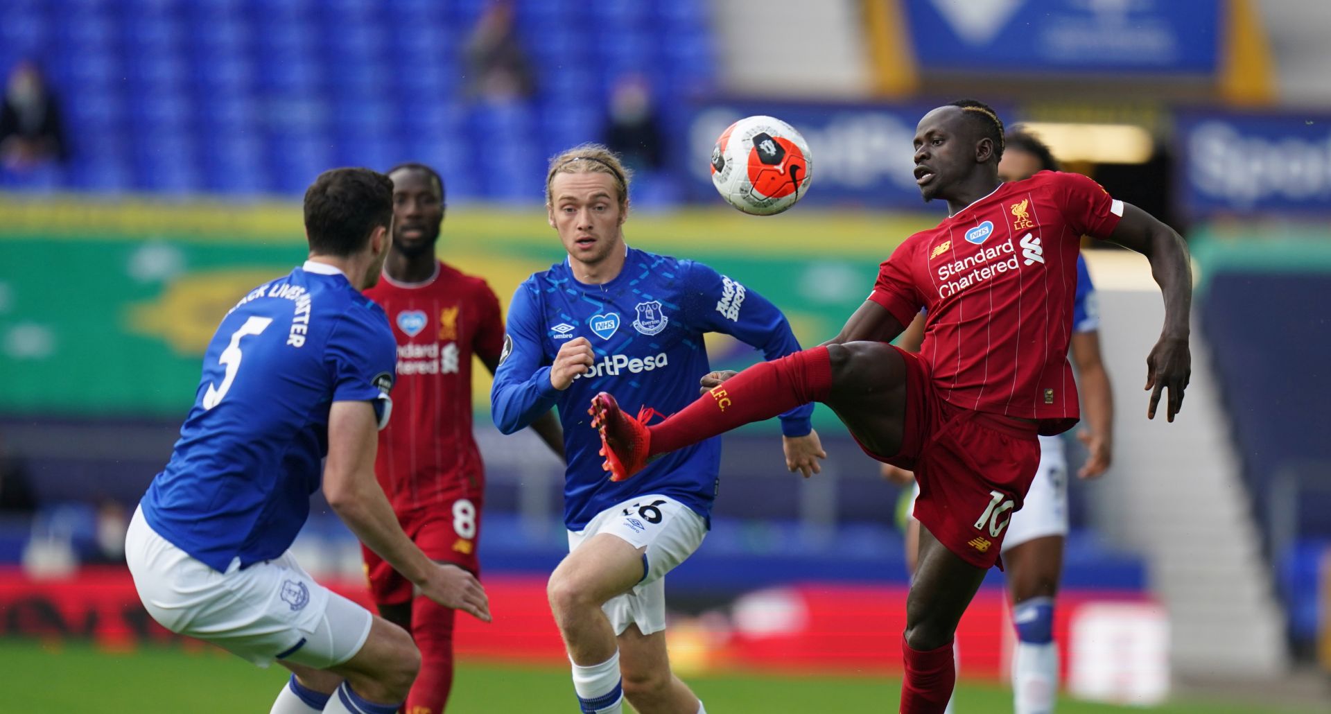 epa08500966 Liverpool's Sadio Mane (R) wins the ball during the English Premier League soccer match between Everton FC and Liverpool FC in Liverpool, Britain, 21 June 2020.  EPA/JON SUPER/ NMC / AP POOL EDITORIAL USE ONLY. No use with unauthorized audio, video, data, fixture lists, club/league logos or 'live' services. Online in-match use limited to 120 images, no video emulation. No use in betting, games or single club/league/player publications.